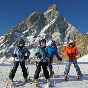 Child learning to ski on beginner terrain cervinia ski school kids